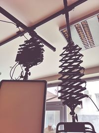 Low angle view of electric lamp hanging on ceiling