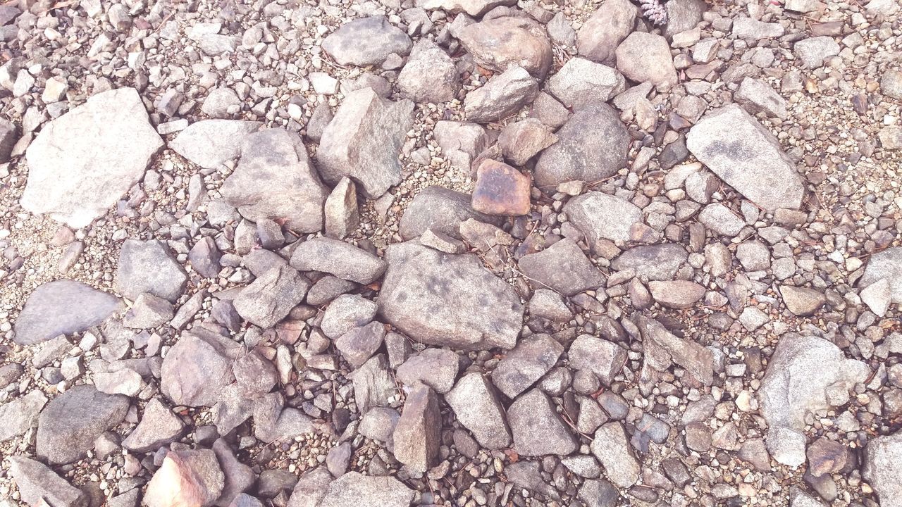 full frame, backgrounds, stone - object, solid, rock, textured, no people, stone, nature, pebble, rock - object, close-up, day, large group of objects, pattern, abundance, rough, outdoors, high angle view, directly above, textured effect