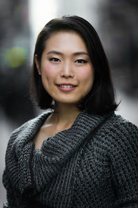 Close-up portrait of smiling young woman outdoors