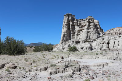 Scenic view of rocky mountains against clear blue sky