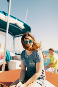 Man wearing sunglasses sitting outdoors