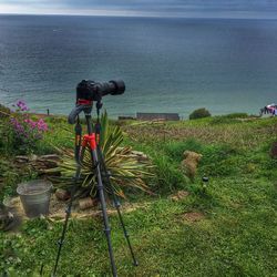 People photographing sea against sky