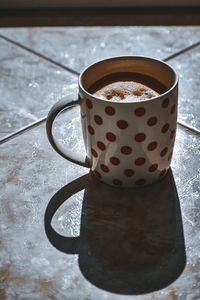 High angle view of coffee cup on table