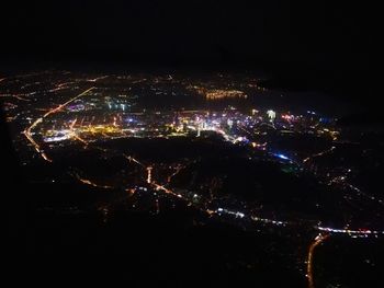 Aerial view of illuminated city at night