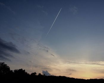 Low angle view of vapor trails in sky