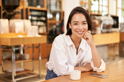 Young businesswoman working at table