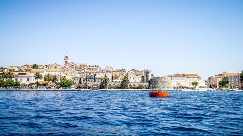 Scenic view of river against clear blue sky