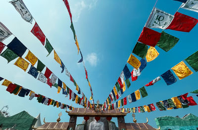 Low angle view of prayer flags against sky