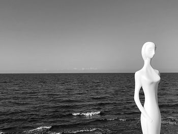 Statue against sea and clear sky