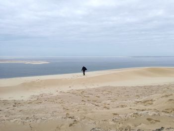 Man on beach against sky