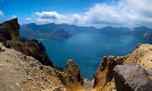 Scenic view of mountains against cloudy sky