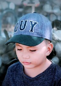 Close-up of boy wearing cap outdoors