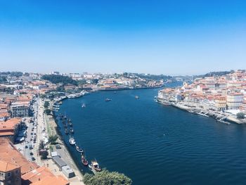 High angle view of townscape by sea against clear sky