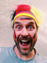 Portrait of happy german soccer fan against wall