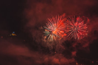 Low angle view of firework display at night