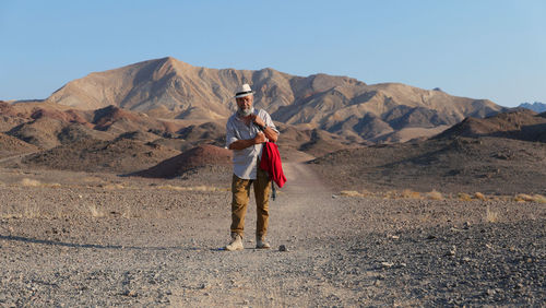 Senior walking on mountain in the desert 