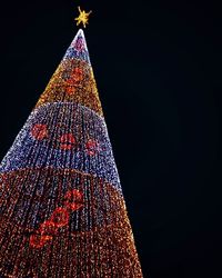 Low angle view of illuminated christmas tree at night