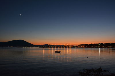 Scenic view of lake against clear sky during sunset