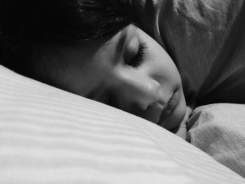 Close-up of baby sleeping on bed