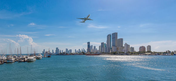 Scenic view of sea and buildings against sky