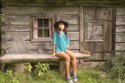 Portrait of woman sitting on wood