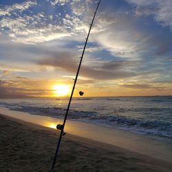 Scenic view of beach against sky during sunset