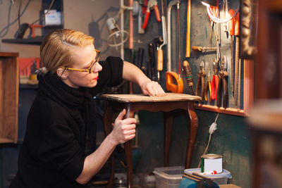 Mature woman in workshop