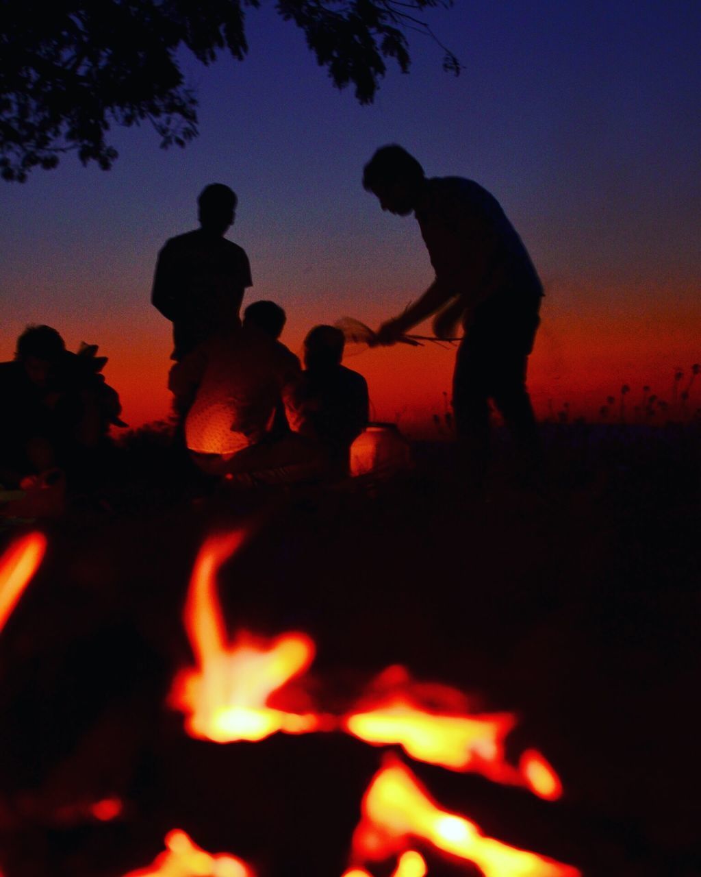 SILHOUETTE PEOPLE STANDING AGAINST SKY AT NIGHT