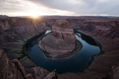 Scenic view of horseshoe bend against sky during sunset