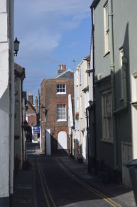 Street amidst buildings in city against sky