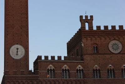 Low angle view of clock tower against clear sky