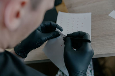 Cropped hand of man holding dentures