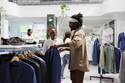 Side view of woman standing in store