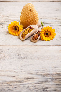 High angle view of yellow flowers on table