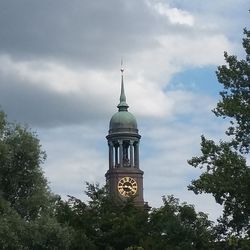 Low angle view of building against cloudy sky