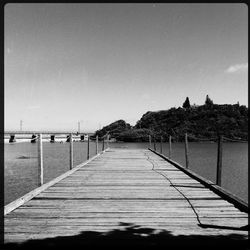 Pier on sea against clear sky