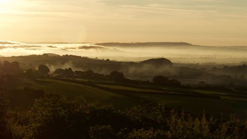 Scenic view of landscape against sky during sunset