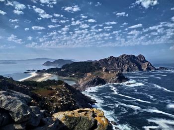 Scenic view of sea and mountains against sky