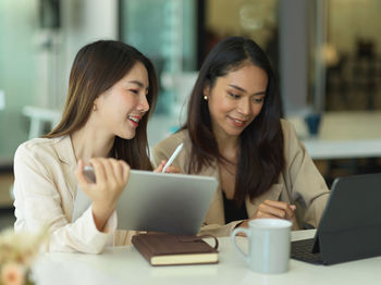 Cheerful businesswomen working in office