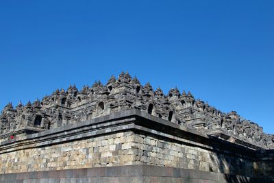 Low angle view of temple against clear blue sky