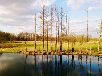 Scenic view of lake against cloudy sky