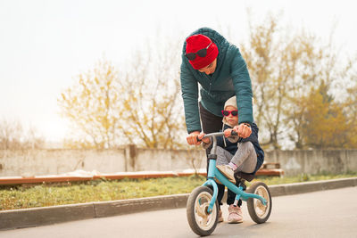 Mother and daughter riding motorcycle