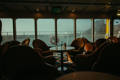 Empty chairs at restaurant in cruise ship