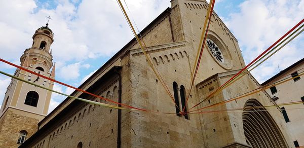 Low angle view of church against cloudy sky