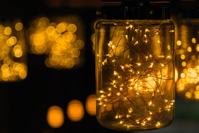 Close-up of illuminated light bulb in jar