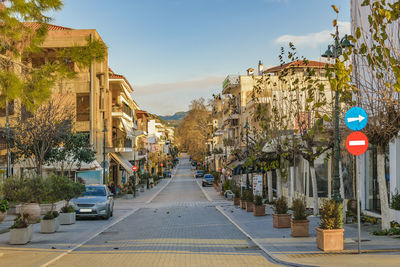 Road amidst buildings against sky