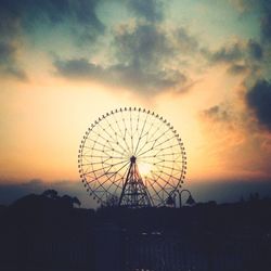 Low angle view of ferris wheel against sky