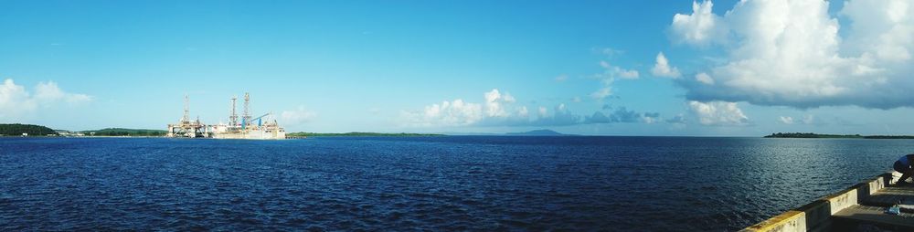 Panoramic view of sea against blue sky