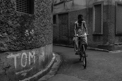 Rear view of man riding bicycle