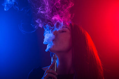 Portrait of woman smoking cigarette